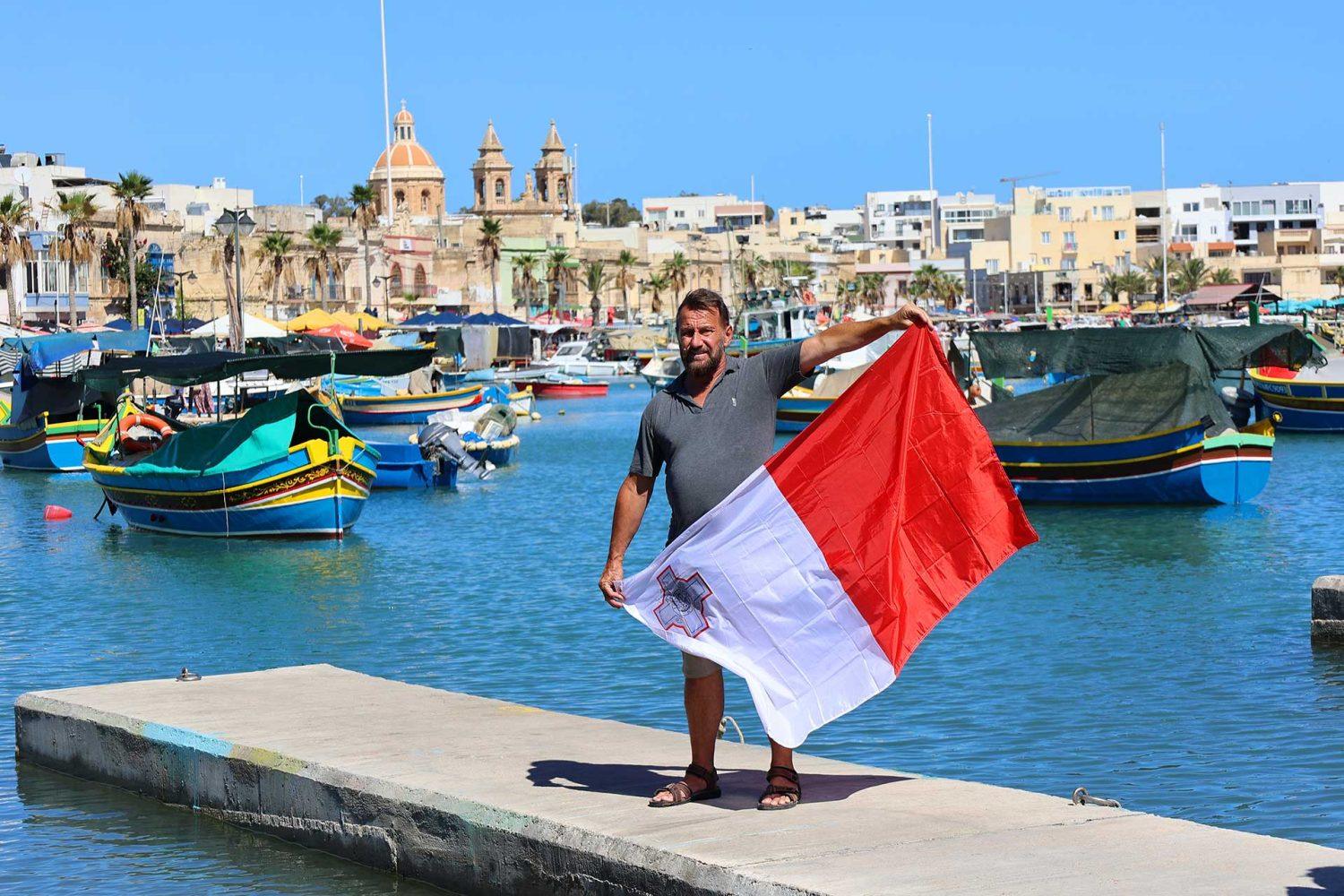 Immigrant in Malta with a flag